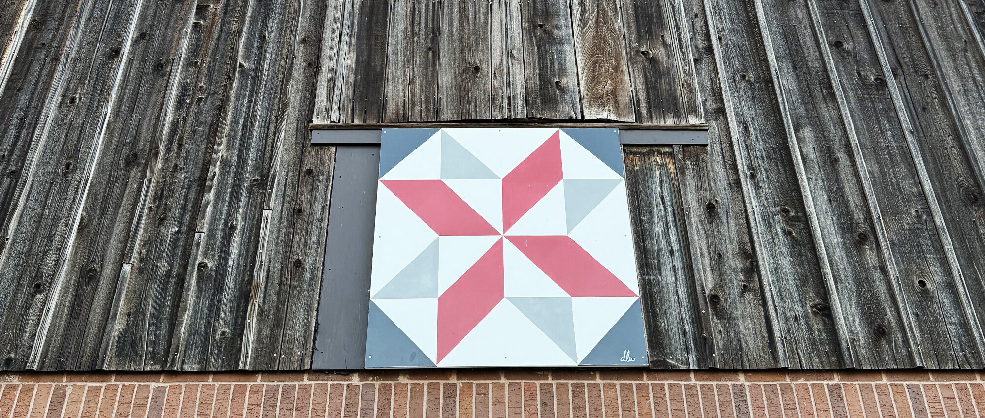 barn-quilt-painting-on-wood-hanging-on-barn