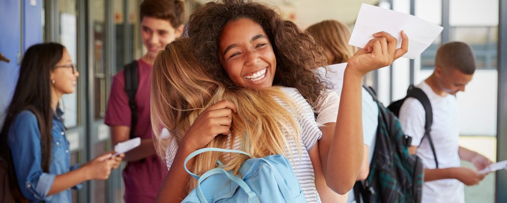 students hugging and celebrating